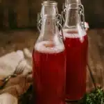 Water kefir in bottles on a rustic table