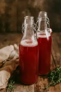Water kefir in bottles on a rustic table